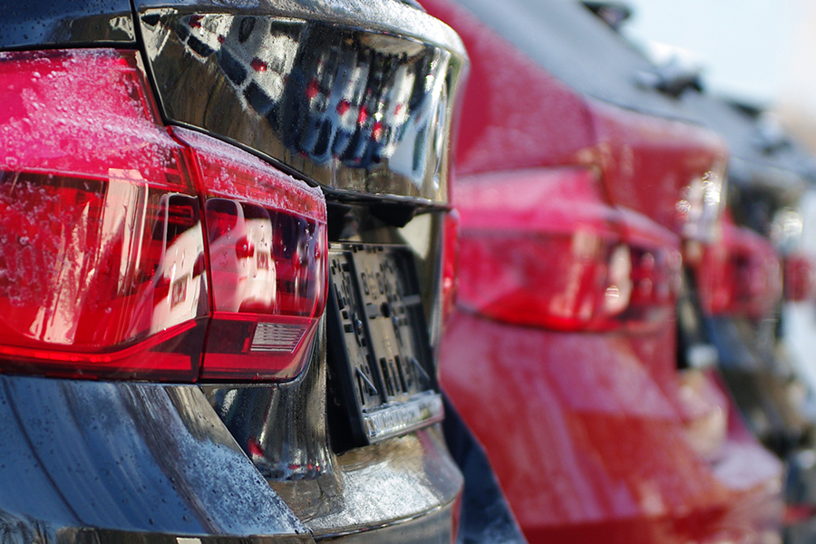 the taillights of a row of cars signifying extended car warranty