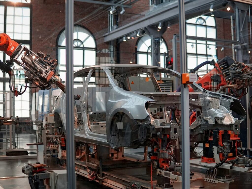 a car factory works on a car frame unibody