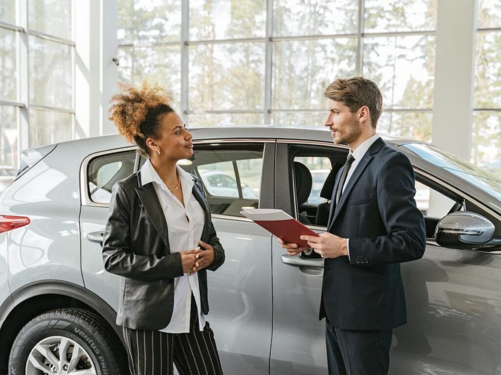 a man and woman perform a car appraisal