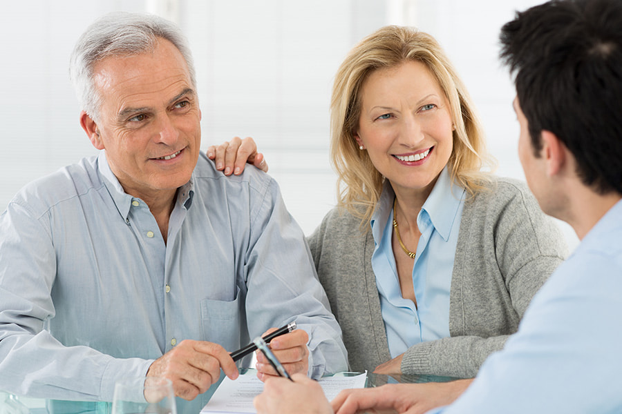 a husband and wife talk to a financial advisor about bonds