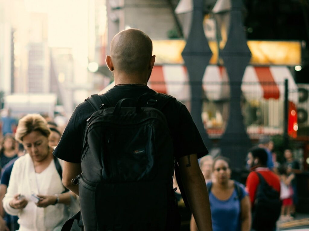 a man walking down the street who is bald