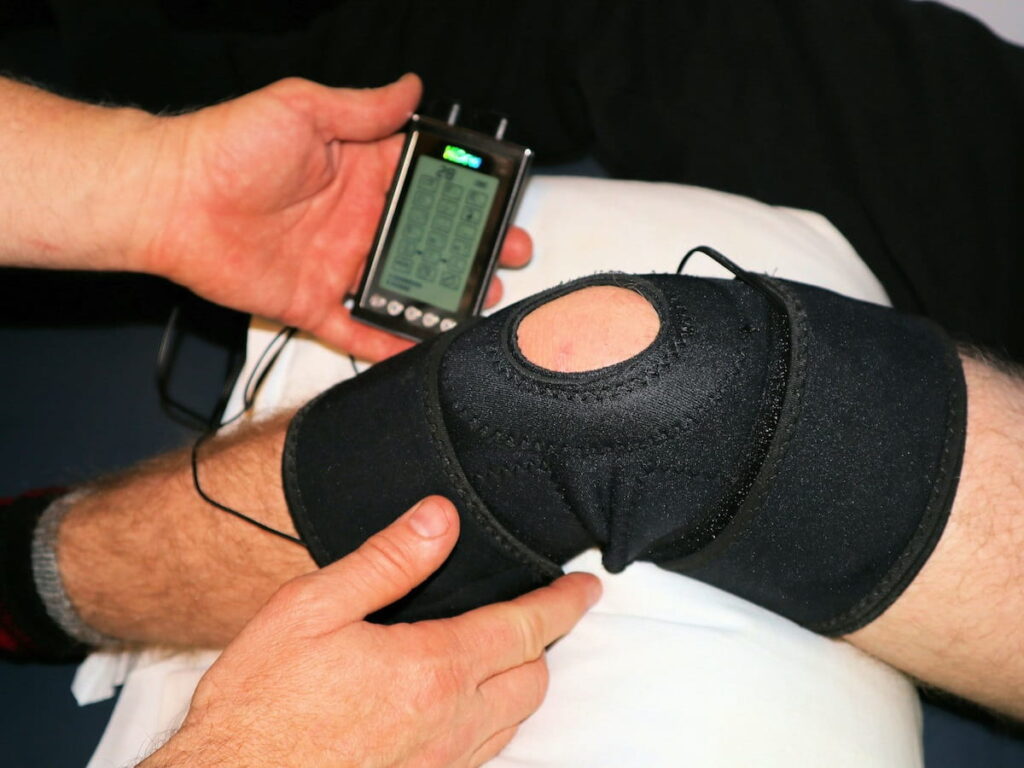 a physical therapist works on a knee to address an ACL issue