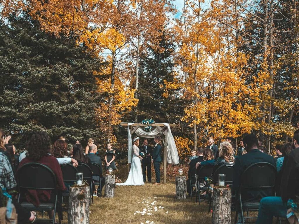 a costly wedding in the fall with color leaves in the background