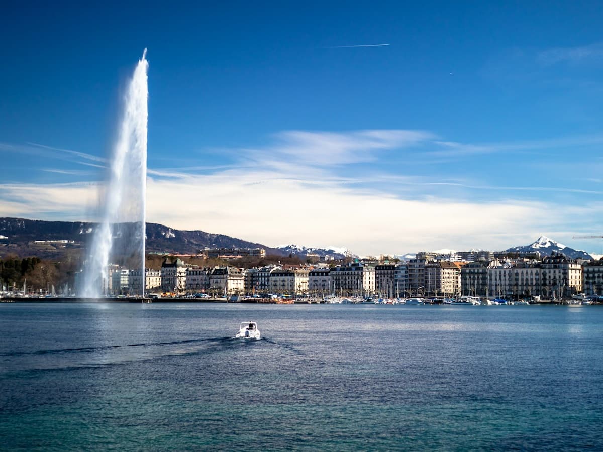 a view from the lake looking towards the buildings of the city geneva switzerland