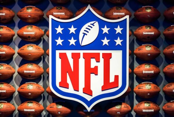 the nfl logo on top of a pattern of footballs