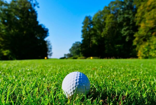 a golf ball sitting in a fairway symbolizing a major pga golf championship tournament