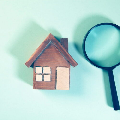 a house and a magnifying glass signifying a not well talked about mortgage clause