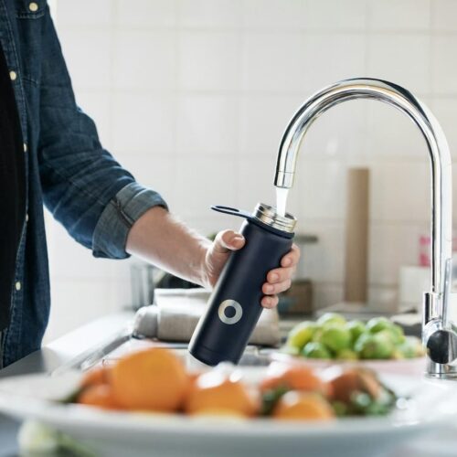 filling a reusable water bottle from the sink and it may have pfas
