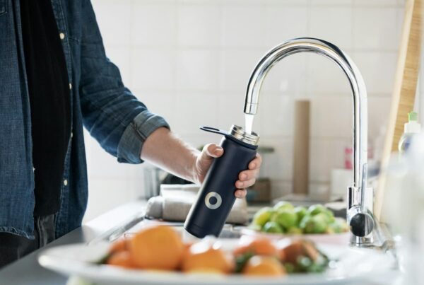 filling a reusable water bottle from the sink and it may have pfas
